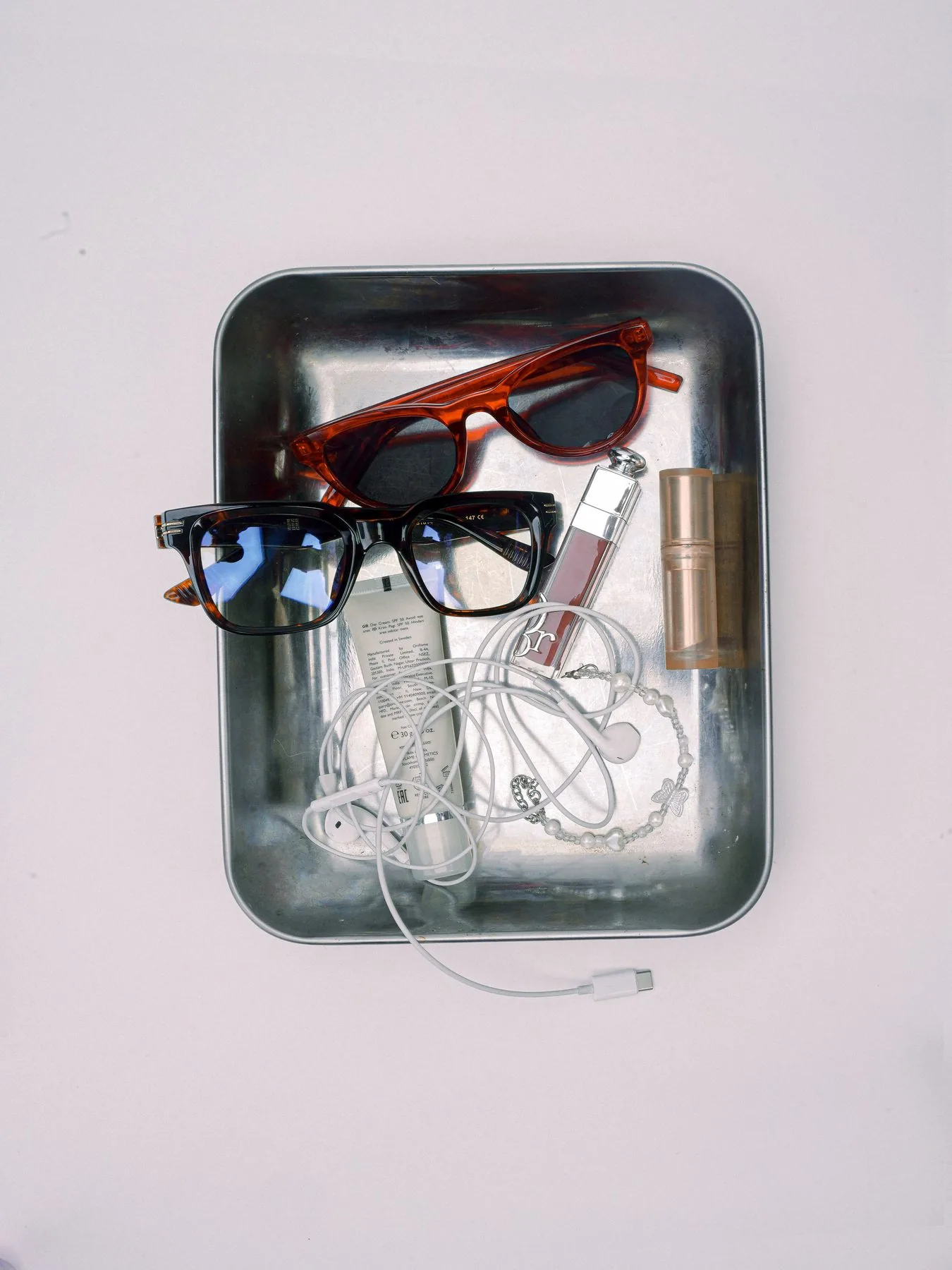 Glasses and everyday extras laid out on a silver tray