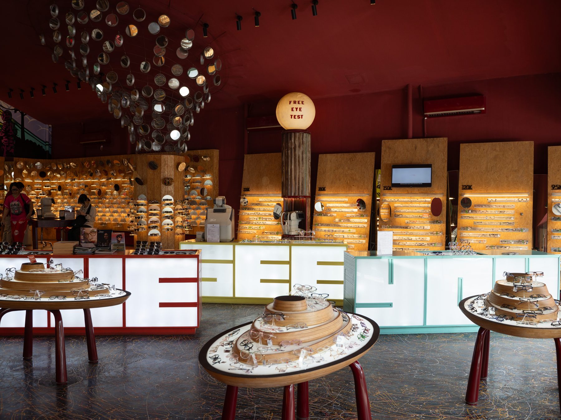 The store interior with a lit SEE sign